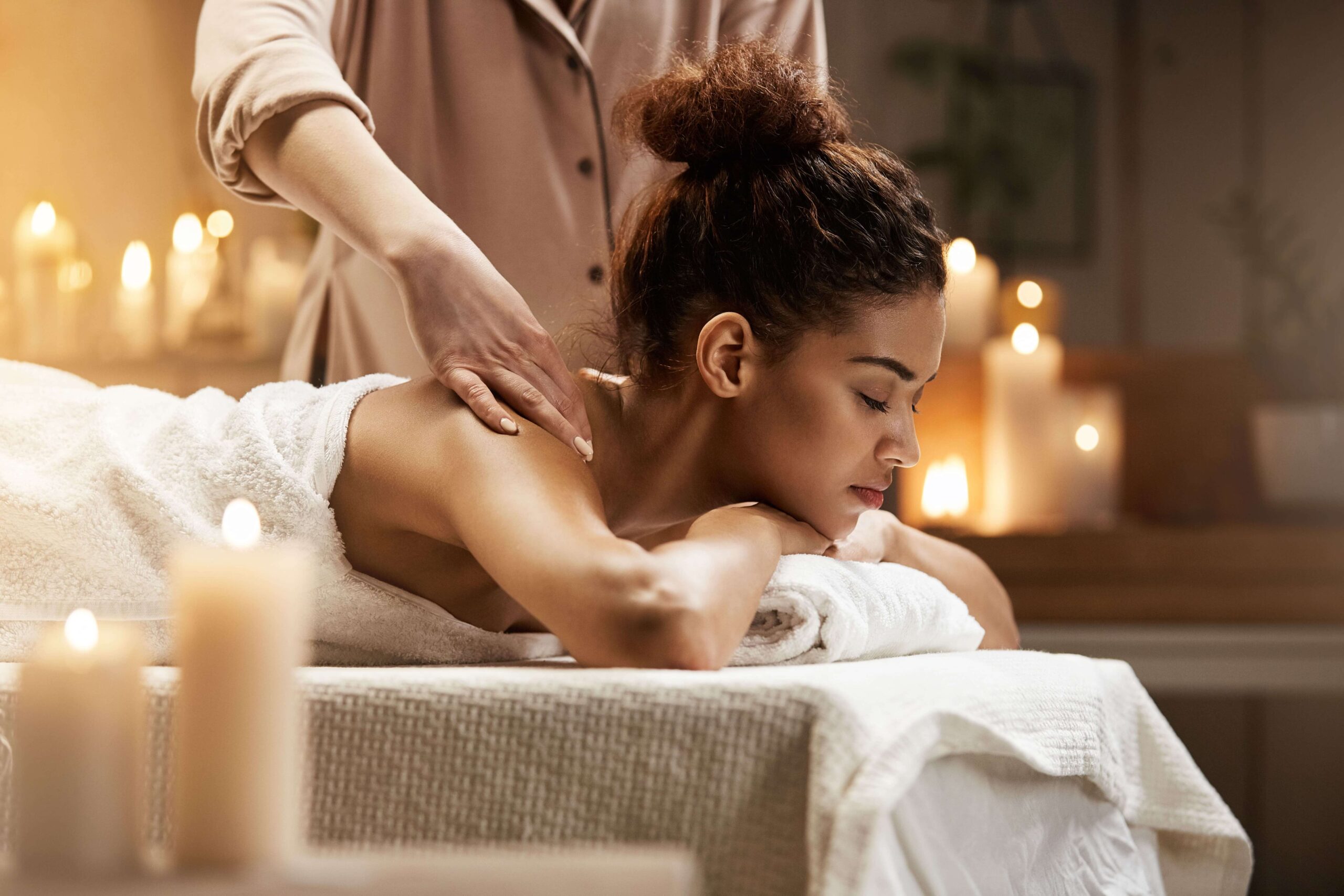 tender-african-woman-smiling-enjoying-massage-with-closed-eyes-spa-resort (1) (1)